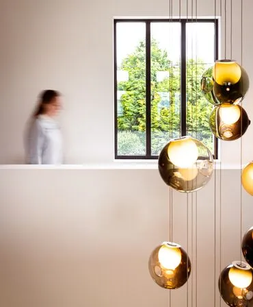 woman walking in modern house with glass windows