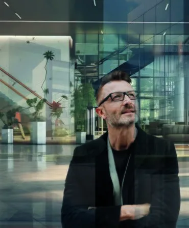 architect looking upwards at Vision 7 glass door